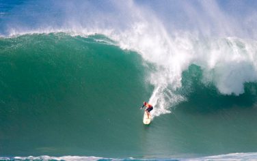 Kelly Slater of Florida drops down the face of this wave during the second round, heat two of the The Quiksilver in Memory of Eddie Aikau surf contest at Waimea Bay located on the north shore of the island of Oahu Tuesday Dec. 8, 2009.  (AP Photo/Eugene Tanner)