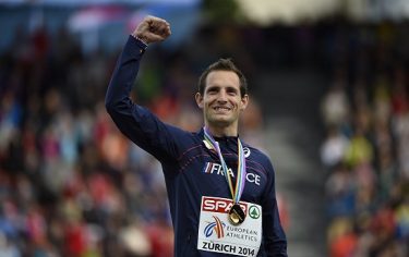 Winner France's Renaud Lavillenie celebrates on the podium during the Men's Pole vault medal ceremony during the European Athletics Championships at the Letzigrund stadium in Zurich on August 16, 2014.  AFP PHOTO / OLIVIER MORIN        (Photo credit should read OLIVIER MORIN/AFP/Getty Images)