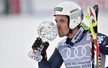 Italy's Peter Fill kisses the downhill's crystal globe trophy after winning the Men's downhill at the FIS Alpine Skiing World Cup finals in St. Moritz on March 16, 2016.   AFP PHOTO / FABRICE COFFRINI / AFP / FABRICE COFFRINI        (Photo credit should read FABRICE COFFRINI/AFP/Getty Images)
