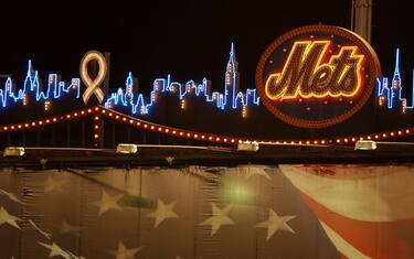 NEW YORK, UNITED STATES:  The neon skyline of New York on the scoreboard in Shea Stadium 21 September 2001 with a ribbon over the rendering of the World Trade Center towers.  The Mets  played their first home game after the attack on the World Trade Center and the Pentagon 11 September. Rescue workers from New York City agencies were honored in a ceremony before the game.  AFP PHOTO/Stan HONDA (Photo credit should read STAN HONDA/AFP/Getty Images)