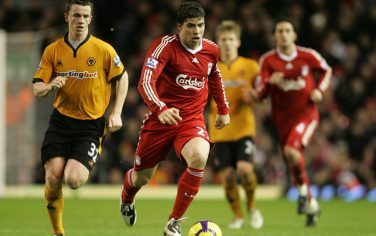 Liverpool's Emiliano Insua, center, gets away from Wolverhampton Wanderers' Kevin Foley during their English Premier League soccer match at Anfield, Liverpool, England, Saturday Dec. 26, 2009. (AP Photo/Tim Hales) ** NO INTERNET/MOBILE USAGE WITHOUT FOOTBALL ASSOCIATION PREMIER LEAGUE (FAPL) LICENCE. CALL +44 (0) 20 7864 9121 or EMAIL info@football-dataco.com FOR DETAILS **