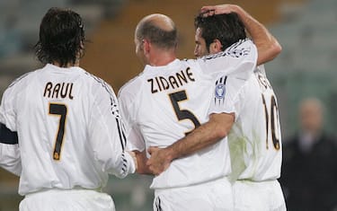 ROME, ITALY:  Real Madrid Figo of Portugal iR) celebrates after scoring a penalty against  AS Roma with teammates Raul and Zinedine Zidane as AS Roma's goalkeeper Ivan Pelizzoli lyes on the pitch during their Champions League group B football match at Rome's Olympic stadium 08 December 2004.    AFP PHOTO/Paolo COCCO  (Photo credit should read PAOLO COCCO/AFP/Getty Images)