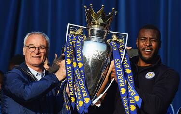 LEICESTER, ENGLAND - MAY 16:  (L-R) Claudio Ranieri Manager of Leicester City and captain Wes Morgan of Leicester City show the trophy to the fans during the Leicester City Barclays Premier League winners bus parade on May 16, 2016 in Leicester, England.  (Photo by Laurence Griffiths/Getty Images)