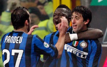 Inter Milan Argentine forward Diego Milito, right, celebrates with teammates Sulley Muntari, of Ghana, center, and Goran Pandev, of Macedonia, after scoring during an Italian Serie A soccer match between Inter Milan and AC Milan at the San Siro stadium in Milan, Italy, Sunday, Jan. 24, 2010. (AP Photo/Alberto Pellaschiar)