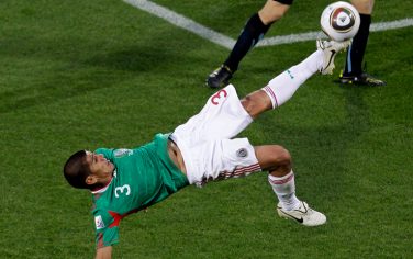 Mexico's Carlos Salcido performs an overhead kick during the ball during the World Cup group A soccer match between Mexico and Uruguay at Royal Bafokeng Stadium in Rustenburg, South Africa, on Tuesday, June 22, 2010.  (AP Photo/Marcio Jose Sanchez)