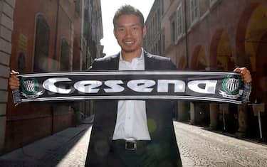 Newly hired Cesena's Japanese defender Yuto Nagatomo shows to photographers the team scarf during his official presentation, in Cesena, Italy, Wednesday, July 14, 2010. Nagatomo signed a two-year contract with the soccer club. (AP Photo/Marco Vasini)