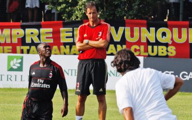 AC Milan coach Massimiliano Allegri, center, flanked by Dutch midfielder Clarence Seedorf, during the first team training session in view of the upcoming Italian Serie A soccer season at the Milanello sporting center, in Carnago, Italy, Tuesday, July 20, 2010. (AP Photo/Luca Bruno)