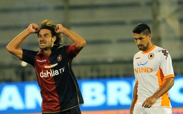 Cagliari's midfielder Daniele Conti (L) celebrates after scoring agains AS Roma during their Italian Serie A football match on September 11, 2010 at Cagliari's Sant'Elia comunal stadium.  AFP PHOTO / ANDREAS SOLARO (Photo credit should read ANDREAS SOLARO/AFP/Getty Images)
