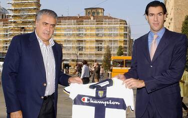 Parma, ITALY:  Former Real Madrid president Lorenzo Sanz (L) shows a Parma's jersey as he poses with his son Lorenzo jr 23 September 2005. Sanz has moved a step closer to becoming the first non-Italian owner of a Serie A club after paid  7.5 million euros ($9.1 million) for the acquisition of the Italian Parma Football Club. Parma have been in search of a buyer since the collapse of their parent company Parmalat in December 2003.  AFP PHOTO/ Nico CASAMASSIMA  (Photo credit should read NICO CASAMASSIMA/AFP/Getty Images)