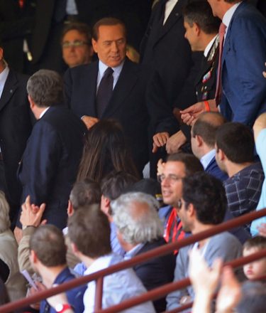 Italian Prime Minister Silvio Berlusconi (C) arrives to take his seat during the serie A match AC Milan against Sampdoria, on May 1, 2011, at the San Siro stadium in Milan .  Prime Minister Silvio Berlusconi will attend a court hearing in Milan on May 2, 2011, his defence team said, as the billionaire Italian tycoon fights off multiple fraud and sex crime allegations.  AFP PHOTO / OLIVIER MORIN (Photo credit should read OLIVIER MORIN/AFP/Getty Images)