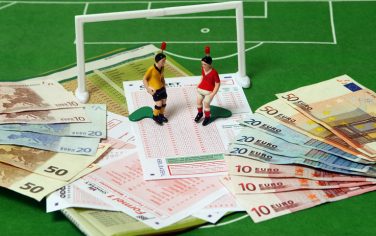 DINSLAKEN, GERMANY - OCTOBER 02:  This photo illustration shows betting slips together with Euro bank notes and a table soccer game on October 2, 2010 in Dinslaken, Germany. The first two suspects in Germany in Europe's biggest football betting scandal ever will face charges in a trial to begin in Bochum on October 6 over attempting to rig at least 24 matches in Europe, including matches in Germany's second division 2. Bundesliga league. In all prosecutors are investigating 250 suspects for attempting to influence the outcome of some 270 matches across Europe. Prosecutor claim the betting ring made profits of at least EUR 7.5 million on manipulated games.  (Photo Illustration by Lars Baron/Bongarts/Getty Images)