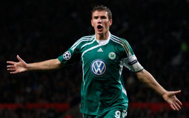Wolfburg's Edin Dzeko celebrates after scoring a goal against Manchester United during their Champions League group B soccer match at Old Trafford Stadium, Manchester, England, Wednesday Sept. 30, 2009. (AP Photo/Jon Super)