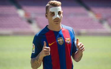 Barcelona's new player French defender Lucas Digne givs the thumbs up during his official presentation at the Camp Nou stadium in Barcelona, after signing his new contract with the Catalan club, on July 14, 2016.  / AFP / JOSEP LAGO        (Photo credit should read JOSEP LAGO/AFP/Getty Images)