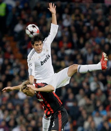 Real Madrid's Kaka of Brazil, top, jumps for the ball with AC Milan Massimo Ambrosini, bottom, during their their UEFA Champions League soccer match at the Santiago Bernabeu stadium in Madrid, on Wednesday, Oct. 21, 2009. (AP Photo/Victor R. Caivano)