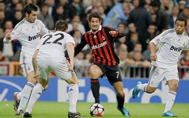 AC Milan's Pato of Brazil , center, runs with the ball pass Real Madrid's Marcelo of Brazil, right, and Xabi Alonso, second left, during their their UEFA Champions League soccer match at the Santiago Bernabeu stadium in Madrid, on Wednesday, Oct. 21, 2009. (AP Photo/Victor R. Caivano)
