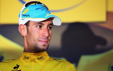LA PLANCHE DES BELLES FILLES, FRANCE - JULY 14:  Vincenzo Nibali of Italy and the Astana Pro Team stands on the podium after winning the stage and regaining the overall race leader's yellow jersey during stage ten of the 2014 Tour de France, a 162km stage between Mulhouse and La Planche des Belles Filles, on July 14, 2014 in La Planche des Belles, France.  (Photo by Bryn Lennon/Getty Images)