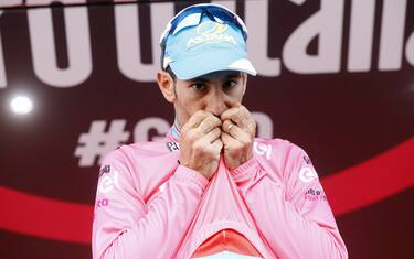 Italian Vincenzo Nibali of team Astana celebrates the pink jersey of the overall leader on the podium of the 20th stage of the 99th Giro d'Italia, Tour of Italy, from  Guillestre to Sant'Anna di Vinadio on May 28, 2016. 
Starting the day second at 44sec behind leader Esteban Chaves, Italian Vincenzo Nibali puts 1min 35sec into the Colombian to snatch the pink jersey. / AFP / LUK BENIES        (Photo credit should read LUK BENIES/AFP/Getty Images)