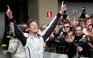 Brawn GP's Jenson Button, of Britain, celebrates after he secured the F1 World Championship by arriving fifth during Brazil's Grand Prix at the Interlagos race track in Sao Paulo, Sunday, Oct. 18, 2009. (AP Photo/Ricardo Mazalan)