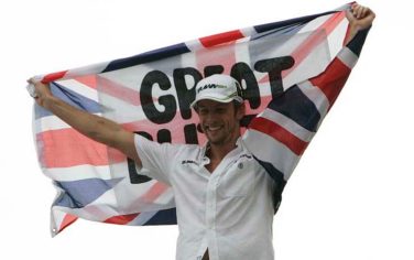 Brawn GP's driver Jenson Button, of Britain, waves his country's flag after he secured the F1 World Championship by arriving fifth during Brazil's Grand Prix at the Interlagos race track in Sao Paulo, Sunday, Oct. 18, 2009. (AP Photo/Andre Penner)