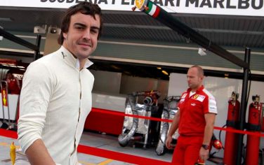 Renault driver Fernando Alonso of Spain walks through the Ferrari pit, during the first free practice session at the Yas Marina racetrack, in Abu Dhabi, United Arab Emirates, Friday, Oct. 30, 2009. The Emirates Formula One Grand Prix will take place on Sunday, Nov. 1. (AP Photo/Luca Bruno)