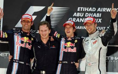 From left, second place Red Bull driver Mark Webber of Australia, Red Bull Racing team sport director Christian Horner, winner, Red Bull driver Sebastian Vettel of Germany and third place Brawn GP driver Jenson Button of Britain react on the podium after the Abu Dhabi Formula One Grand Prix at the Yas Marina racetrack , in Abu Dhabi, United Arab Emirates, Sunday, Nov. 1, 2009. (AP Photo/Luca Bruno)