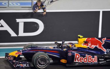 Red Bull driver Sebastian Vettel of Germany and his mechanics react after he won the Abu Dhabi Formula One Grand Prix at the Yas Marina racetrack in Abu Dhabi, United Arab Emirates, Sunday, Nov. 1, 2009. (AP Photo/Gero Breloer)