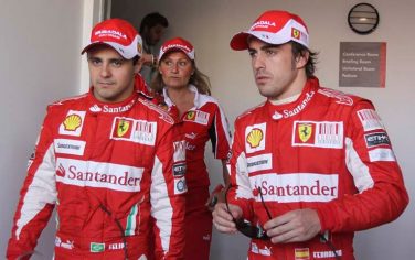 Ferrari driver Felipe Massa of Brazil, left, second fastest time, and his teammate Ferrari driver Fernando Alonso of Spain leaves the conference room after the qualifying session at the Formula One Bahrain International Circuit in Sakhir, Bahrain, Saturday, March 13, 2010. (AP Photo/Hasan Jamali)