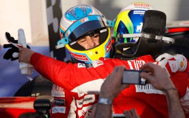 Ferrari driver Fernando Alonso of Spain, left is embraced by his teammate Ferrari driver Felipe Massa of Brazil as he celebrates his victory after the Formula One Bahrain Grand Prix, at the Bahrain International Circuit in Sakhir, Bahrain, Sunday, March 14, 2010. (AP Photo/Luca Bruno)