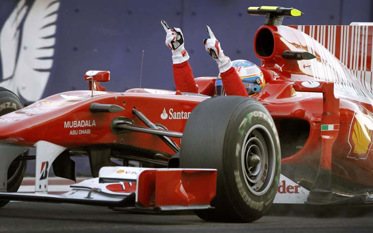 Ferrari driver Fernando Alonso of Spain celebrates after passing the finish line to win the Bahrain Formula One Grand Prix at the Bahrain International Circuit in Sakhir, Bahrain Sunday, March 14, 2010. (AP Photo/Ben Curtis)