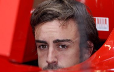 Ferrari Formula One driver Fernando Alonso of Spain waits in his before the start of the third practice session for the Chinese Formula One Grand Prix at the Shanghai International Circuit in Shanghai, China, Saturday, April 17, 2010. (AP Photo/Mark Baker)