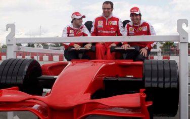 Ferrari Formula One driver Fernando Alonso of Spain, left, team Director Stefano Domenicali, centre and Felipe Massa of Brazil sit in a Ferrari fairground attraction that is presented at the circuit in Montmelo just outside Barcelona, Spain Thursday May 6, 2010 ahead of Sunday's Spanish Grand Prix. (AP Photo/Paul White)