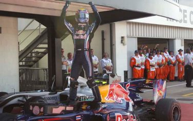 Red Bull Formula One driver Mark Webber of Australia stands on his car as he celebrates his win at the British Formula One Grand Prix  in Silverstone, England, Sunday, July 11, 2010. (AP Photo/Mark Baker)