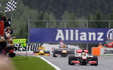 McLaren Mercedes driver Lewis Hamilton of Britain crosses the finish line to win the Belgium Formula One Grand Prix in Spa-Francorchamps circuit, Belgium, Sunday, Aug. 29, 2010. In background is second placed Red Bull driver Mark Webber of Australia and third placed Renault driver Robert Kubica of Poland. (AP Photo/Luca Bruno)