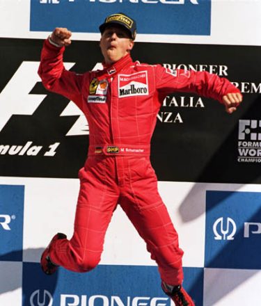8 Sep 1996:  Ferrari driver Michael Schumacher of Germany jumps for joy on the podium after winning a stunning race after the Italian Formula One Grand Prix held in Monza, Italy. \ Mandatory Credit: Michael Cooper /Allsport