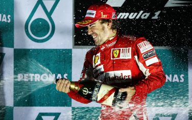 YEONGAM GUN, SOUTH KOREA - OCTOBER 24:  Fernando Alonso of Spain and Ferrari celebrates on the podium after winning the Korean Formula One Grand Prix at the Korea International Circuit on October 24, 2010 in Yeongam-gun, South Korea.  (Photo by Paul Gilham/Getty Images) *** Local Caption *** Fernando Alonso