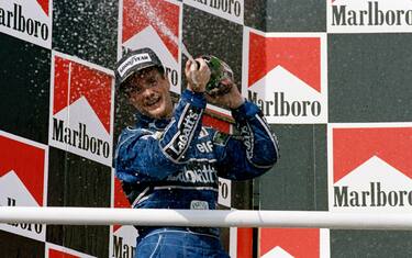 Nigel Mansell driver of the #5 Canon Williams Renault Williams FW14 Renault 3.5 V10 sprays the champagne as he celebrates winning the World Championship at the Grand Prix of Hungary on 11th August 1992 at the Hungaroring Circuit, Budapest, Hungary. (Photo by Mike Hewitt/Getty Images)
