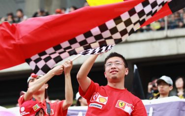 SHANGHAI, CHINA - APRIL 15:  Local fans of Ferrari team are seen before the start of the Chinese Formula One Grand Prix at the Shanghai International Circuit on April 15, 2012 in Shanghai, China.  (Photo by Mark Thompson/Getty Images)