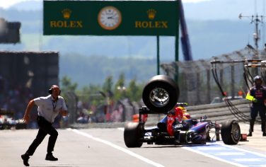 Red Bull Racing's Australian driver Mark Webber loses a tyre as he leaves the pits at the Nurburgring race track on July 7, 2013 in Nurburg during the German Formula One Grand Prix. AFP PHOTO / SRDJAN SUKI        (Photo credit should read SRDJAN SUKI/AFP/Getty Images)