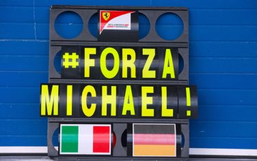 epa04046655 A pit board with the lettering '#FORZA MICHAEL' seen in front of the teamgarage of Ferrari during the training session for the upcoming Formula One season at the Jerez racetrack in Jerez de la Frontera, Southern Spain, 29 January 2014. Michael Schumacher's manager declined to comment 29 January on reports that doctors in France have begun the process of bringing the Formula One legend out of an artificial coma, one month since his skiing accident.  EPA/JENS BUETTNER -