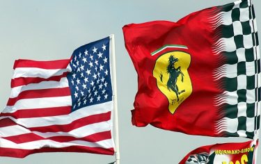 INDIANAPOLIS, UNITED STATES:  The team Ferrari flag (R) flies next to the US flag during practice 27 September, 2002 in Indianapolis. Teams are preparing cars for the Formula One USA Grand prix scheduled to take place in Indianapolis 29 September.  AFP PHOTO/Don EMMERT (Photo credit should read DON EMMERT/AFP/Getty Images)