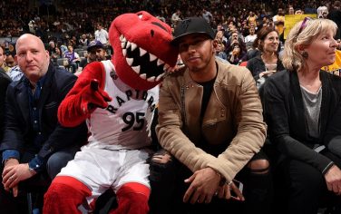 TORONTO, CANADA - December 7:  Formula One Driver, Lewis Hamilton poses for a photo with The Raptor during the Los Angeles Lakers game against the Toronto Raptors on December 7, 2015 at the Air Canada Centre in Toronto, Ontario, Canada. NOTE TO USER: User expressly acknowledges and agrees that, by downloading and or using this Photograph, user is consenting to the terms and conditions of the Getty Images License Agreement.  Mandatory Copyright Notice: Copyright 2015 NBAE (Photo by Ron Turenne/NBAE via Getty Images)