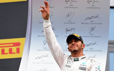SPIELBERG, AUSTRIA - JULY 03: Lewis Hamilton of Great Britain and Mercedees GP celebrates his win on the podium during the Formula One Grand Prix of Austria at Red Bull Ring on July 3, 2016 in Spielberg, Austria.  (Photo by Mark Thompson/Getty Images)