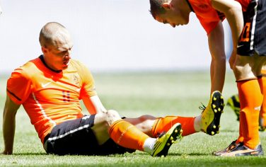 Arjen Robben of The Netherlands grimaces as Ibrahim Afellay, right, holds his leg after suffering a hamstring injury during the friendly soccer match Netherlands versus Hungary at ArenA stadium in Amsterdam, Netherlands, Saturday June 5, 2010. Robben will not fly out to South Africa with the Dutch team in order to determine the exact nature of his injury in a Dutch hospital. (AP Photo/Peter Dejong)