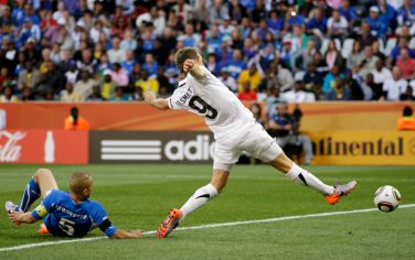 Italy's Fabio Cannavaro, left, fails to block the ball as New Zealand's Shane Smeltz, right, kicks to score a goal during the World Cup group F soccer match between Italy and New Zealand at Mbombela Stadium in Nelspruit, South Africa, Sunday, June 20, 2010.  (AP Photo/Darko Bandic)