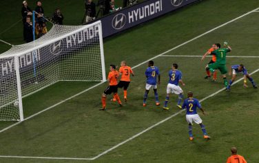 Brazil's Felipe Melo, top right, scores an own goal during the World Cup quarterfinal soccer match between the Netherlands and Brazil at Nelson Mandela Bay Stadium in Port Elizabeth, South Africa, Friday, July 2, 2010.  (AP Photo/Michael Sohn)
