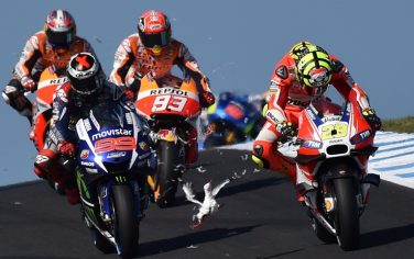 A seagull flies in front of Repsol Honda rider Marc Marquez (C) and Movitar Yamaha rider Jorge Lorenzo of Spain after smashing into Ducati rider Andrea Iannone of Italy on the opening lap of the MotoGP Australian Grand Prix at Phillip Island on October 18, 2015.  IMAGE STRICTLY RESTRICTED TO EDITORIAL USE - STRICTLY NO COMMERCIAL USE   AFP PHOTO/Paul Crock        (Photo credit should read PAUL CROCK/AFP/Getty Images)