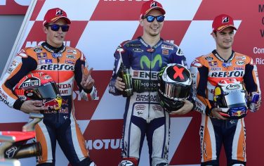 Repsol Honda's Spanish rider Marc Marquez (L), Movistar Yamaha's Spanish rider Jorge Lorenzo (C) and Repsol Honda's Spanish rider Dani Pedrosa pose after the MotoGP qualifying session on the eve of the Valencia Grand Prix at Ricardo Tormo racetrack in Cheste, near Valencia on November 7, 2015.   AFP PHOTO/ JAVIER SORIANO        (Photo credit should read JAVIER SORIANO/AFP/Getty Images)
