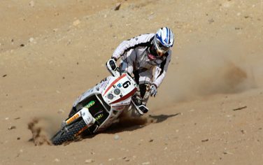 Italian Luca Manca, who took second place in the Pharaons International Cross Country motorbike rally,  drives in the desert at the historical site of the Giza Pyramids, Egypt Saturday, Oct. 10, 2009. (AP Photo/Amr Nabil)