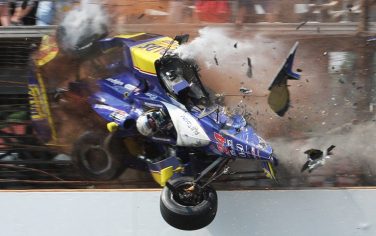 Mike Conway, of England, crashes into the fencing in the third turn during the closing laps of the Indianapolis 500 auto race at Indianapolis Motor Speedway in Indianapolis, Sunday, May 30, 2010. (AP Photo/Kurt Bauer)