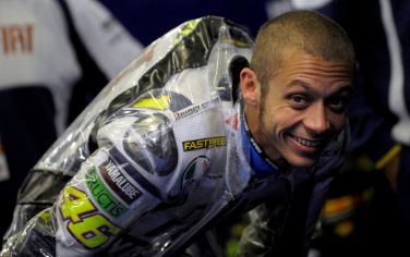 Italian Moto GP rider Valentino Rossi jokes in the pits before the Portugal Moto GP free practice 1, in Estoril, on October 29, 2010. AFP PHOTO / MIGUEL RIOPA (Photo credit should read MIGUEL RIOPA/AFP/Getty Images)